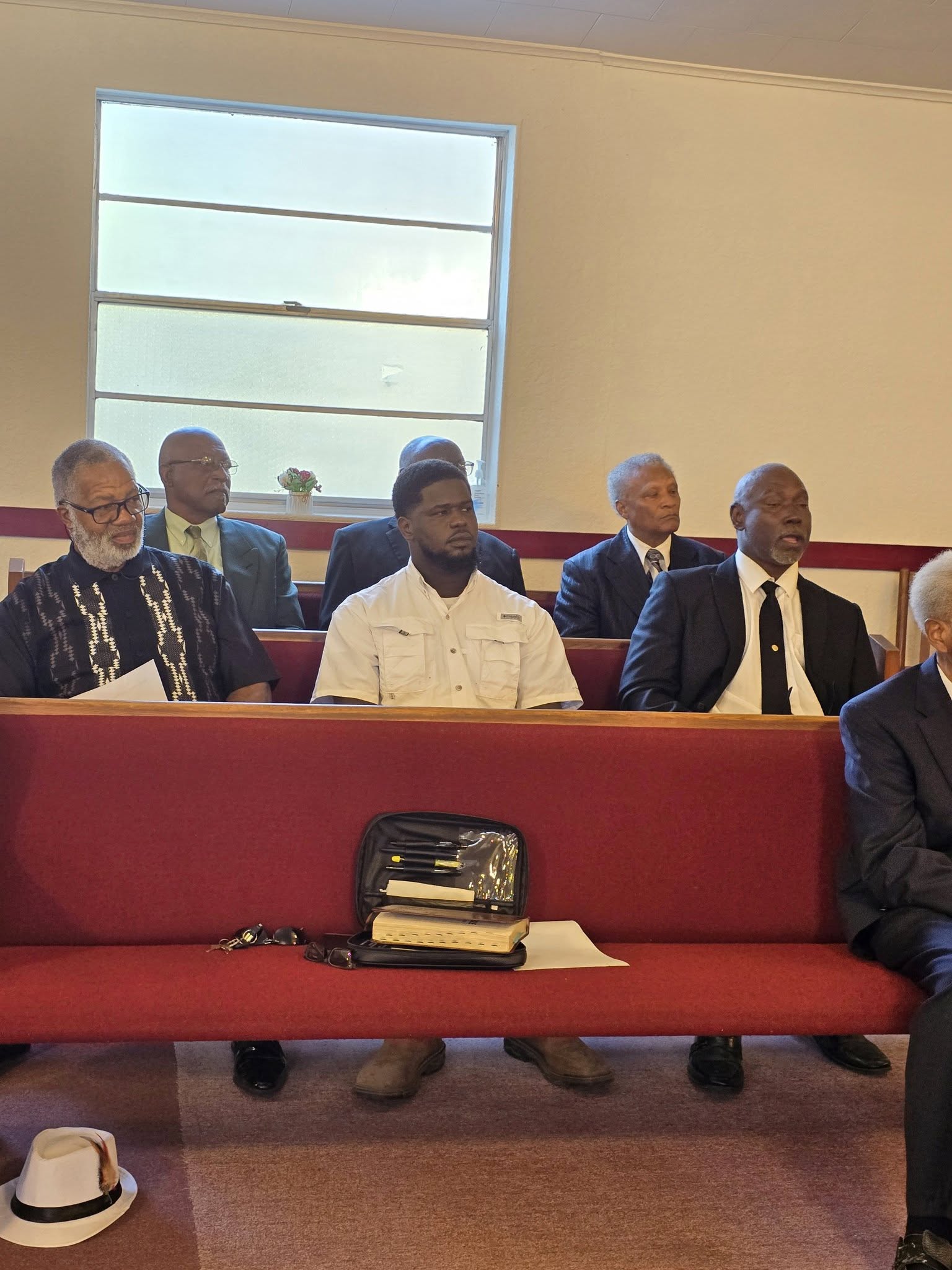 Men seated in worship